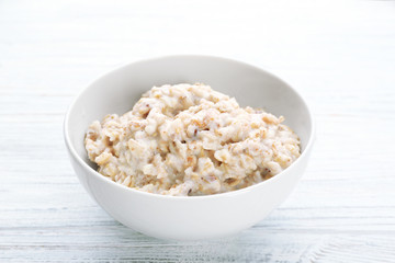 Tasty oatmeal in bowl for breakfast on table