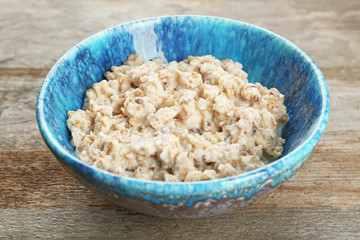 Tasty oatmeal in bowl for breakfast on table