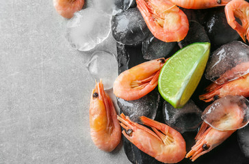 Frozen shrimps with ice on slate plate