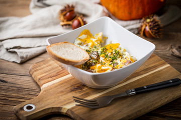 Scrambled eggs with sausage and bread.