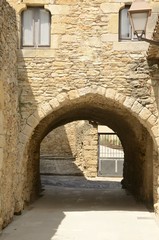 Stone arch on building in Peratallada, Girona, Spain