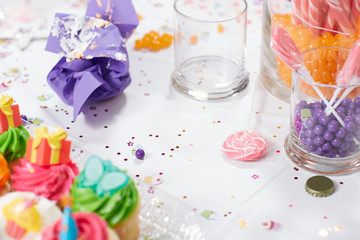 Kids birthday party table with cupcakes and candy