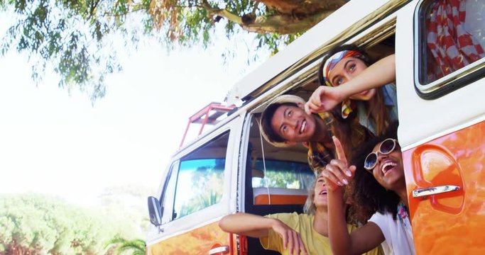 Happy friends enjoying at van door 
