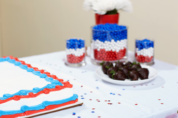 Colorful cake among sweet food on table
