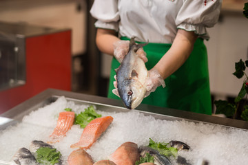 High Angle Still Life of Variety of Raw Fresh Fish Chilling on Bed of Cold Ice in Seafood Market Stall,Fresh seafood on ice in the showcase,Salmon on cooled market display,Supermarket, fish department