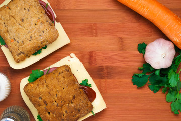 Fototapeta premium Breakfast with a sandwich with cheese and ham and vegetables