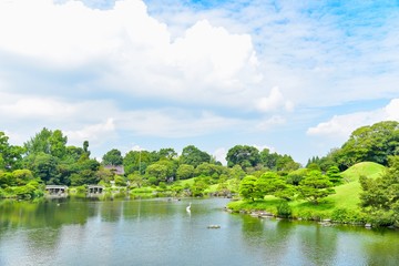 Fototapeta na wymiar Beautiful Scenery of Green Hills and Blue Sky at Suizenji Garden