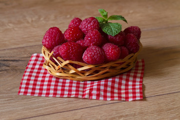 Fresh ripe raspberries in a small basket