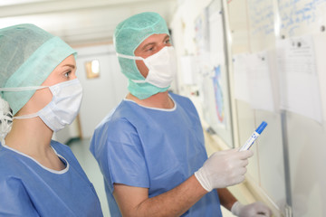 Medical staff looking at whiteboard