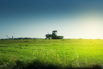 The Combine Operator Getting the Harvest from the green field under the morning sun