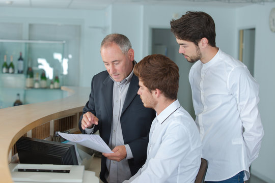 male receptionists locating at counter