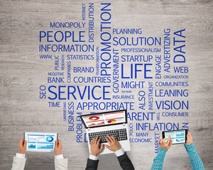 Top view of businesspeople sitting at table and using gadgets