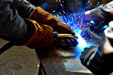 Industrial Worker labourer at the factory welding steel structure