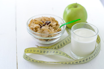 healthy eating, dieting, slimming and weigh loss concept - close up of diet plan paper green apple, muesli, green apple, kefir, milk