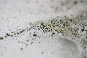 Dirty washing up soap sud bubbles close up in a bowl