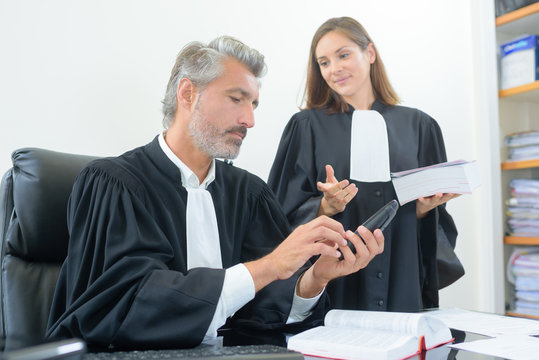 Robed legal workers in discussion