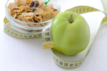 healthy eating, dieting, slimming and weigh loss concept - close up of diet plan paper green apple, muesli, green apple, orange, juice