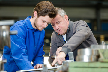 trainee engineer having discussion in factory