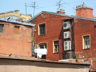 Fototapeta na wymiar Facade and roof of old city courtyard in Saint Petersburg, Russia