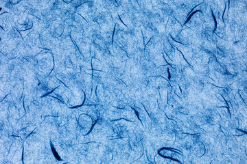 backlit blue paper background with silk fibres