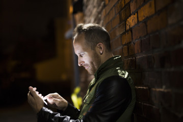 Handsome man using smart phone mobile in the city at night