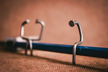 Single nail sitting on pencil bench with the couple nails