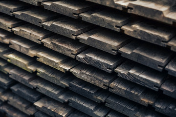 Wooden brown background is from lying horizontally boards. beams wooden boards lying on each other on the market for sale