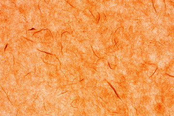backlit orange paper background with silk fibres