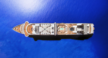 Aerial view of luxury cruise ship at blie ocean, top down view of swimming pool and deck