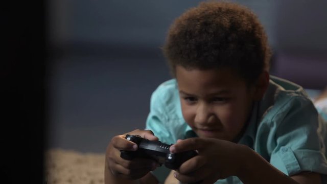 Lonely boy suffering from lack of friends replacing them with game console