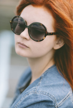 portrait of  young woman  with round retro sunglasses