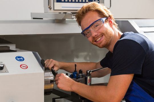 Fitter working at Turning machine in metal workshop