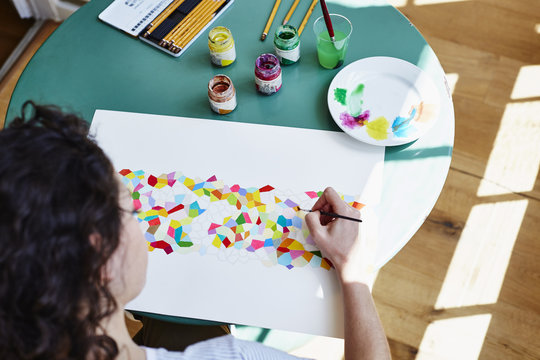Young Woman Drawing At Table