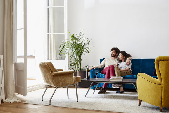 Couple Having Wine While Sitting On Sofa - Powered by Adobe