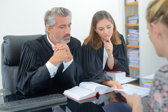 2 lawyers with female client in the office