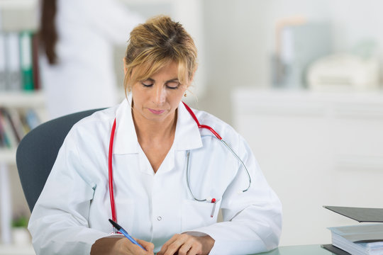female doctor writing