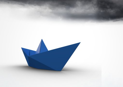 Paper boat with dark clouds