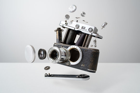 Disassembled analog camera on the white background