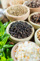 Variety of different asian and middle east spices, colorful assortment, on old wooden table