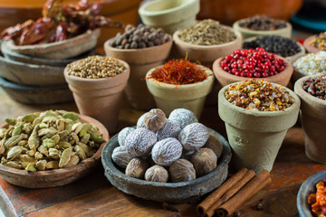 Variety of different asian and middle east spices, colorful assortment, on old wooden table