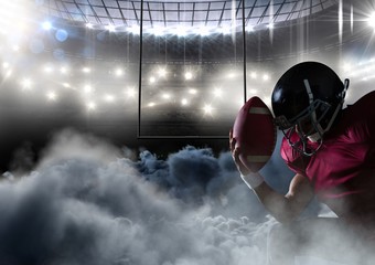 american football player in stadium with smoke