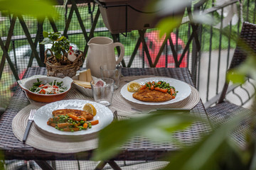 Italian lunch made of cotoletta with carrots and peas