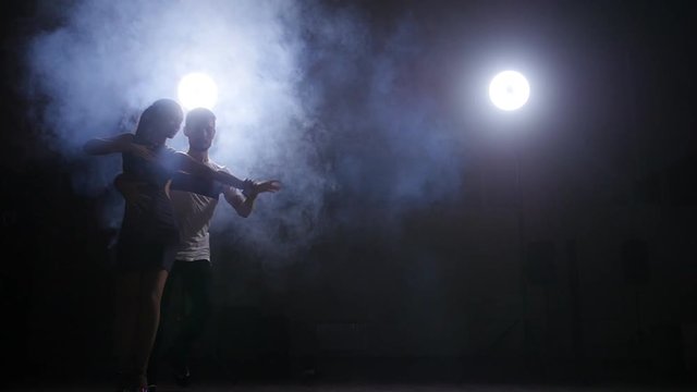 Young couple dancing bachata indoors