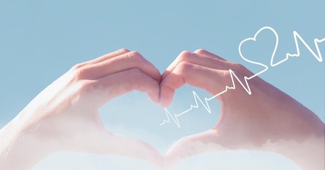 Heart beat over hands holding heart