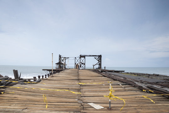 Old rusty pier in Guatemala shot in a cloudy morning. Champerico