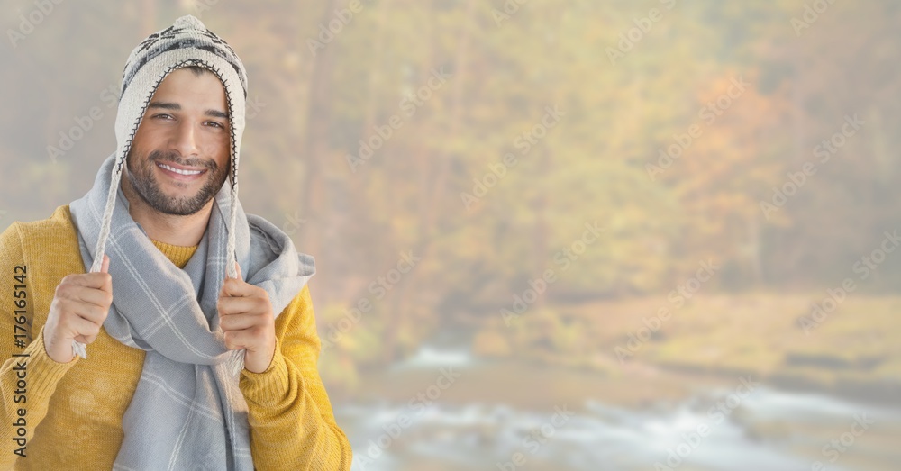 Wall mural Man in Autumn with hat and scarf in bright forest