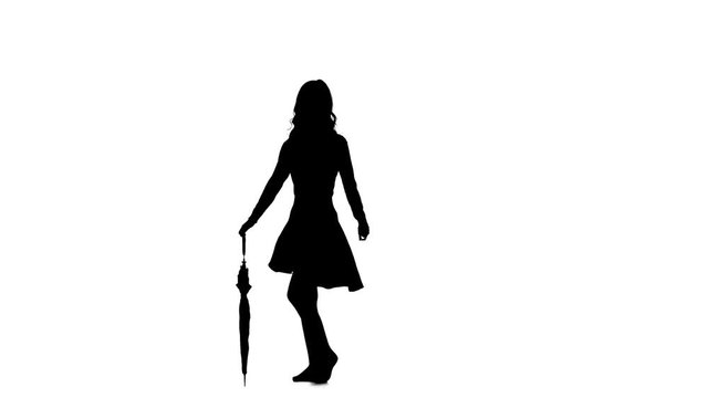 Girl with an umbrella in her hands is dancing. White background. Silhouette