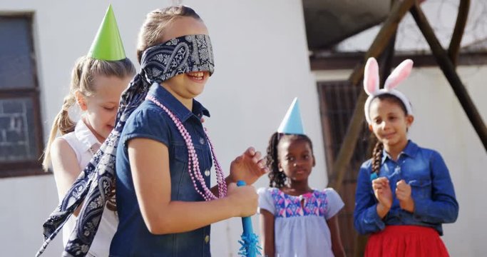Happy friend playing blindfold in backyard 