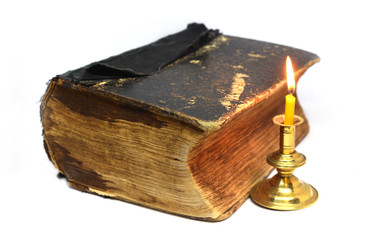 old , antique book and candly on isolated white background