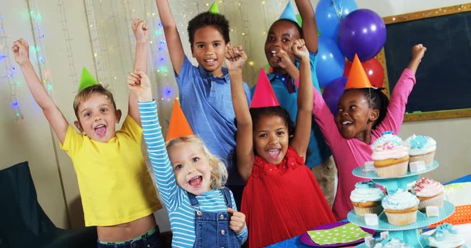 Kids having fun with each other during birthday party 